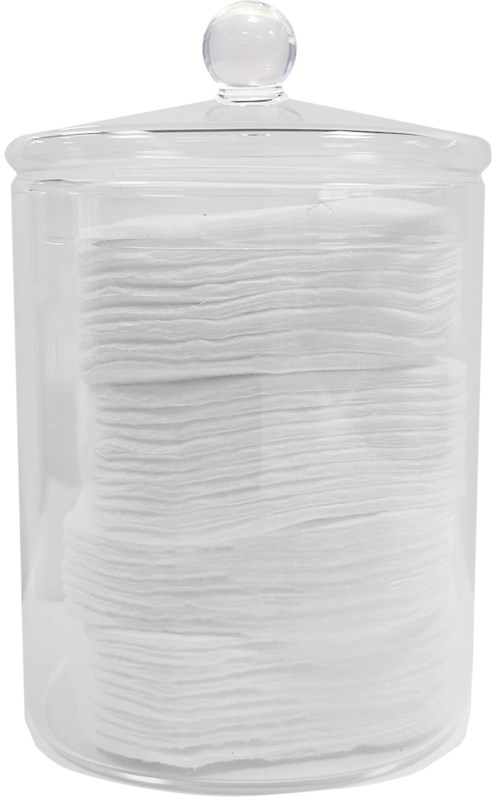 A clear glass jar filled with folded white tissues or cotton pads, with a round knob on top.
