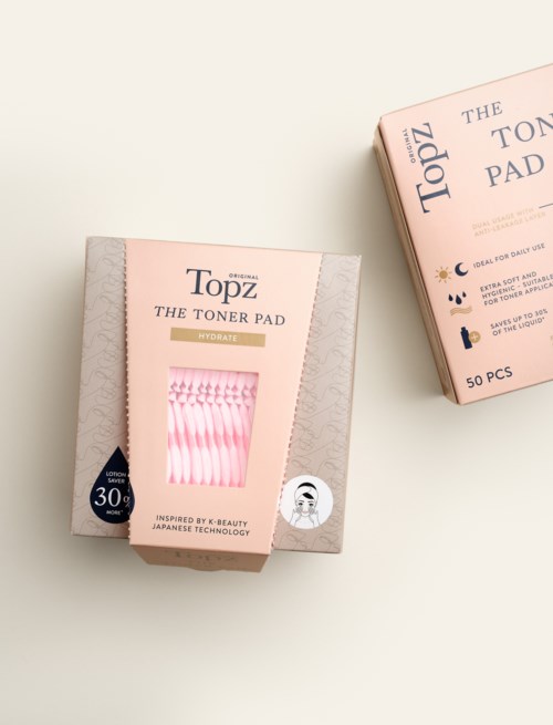 Box of 50 pink toner pads for skincare, inspired by Japanese technology, suitable for weekly use.