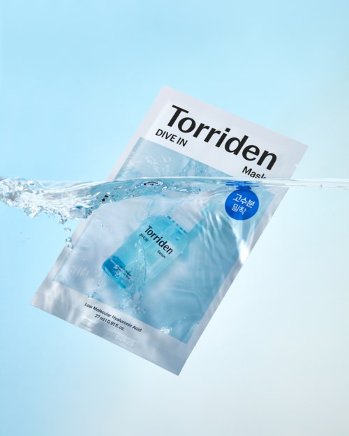 A packet labeled Torriden Dive In Mask submerged in water, with some water splash around it.