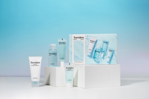 A set of skincare products arranged on white blocks with a blue background. The products include tubes, bottles, and a box.