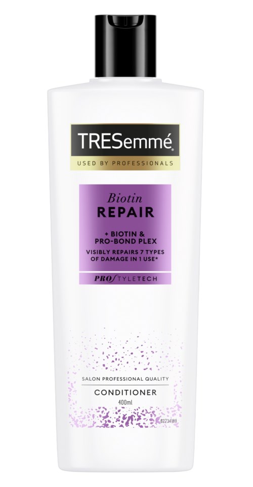 A white bottle with a black cap, labeled 'TRESemmé' and 'Biotin Repair Conditioner' for hair care.