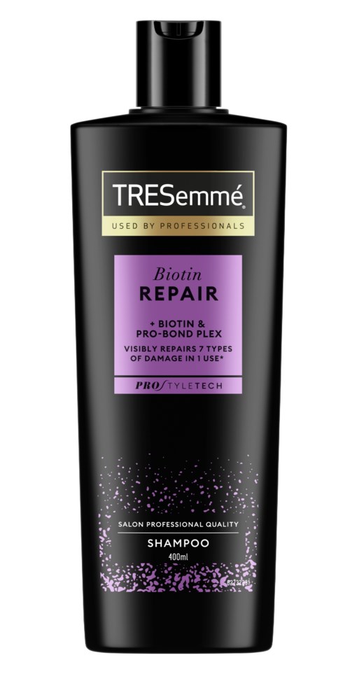 A black shampoo bottle labeled TRESemmé Biotin Repair with purple and gold text, and a purple design at the bottom.