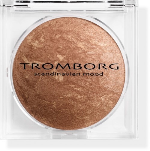 A round, bronze makeup product in a clear square case with black text reading "TROMBORG" and "scandinavian mood."