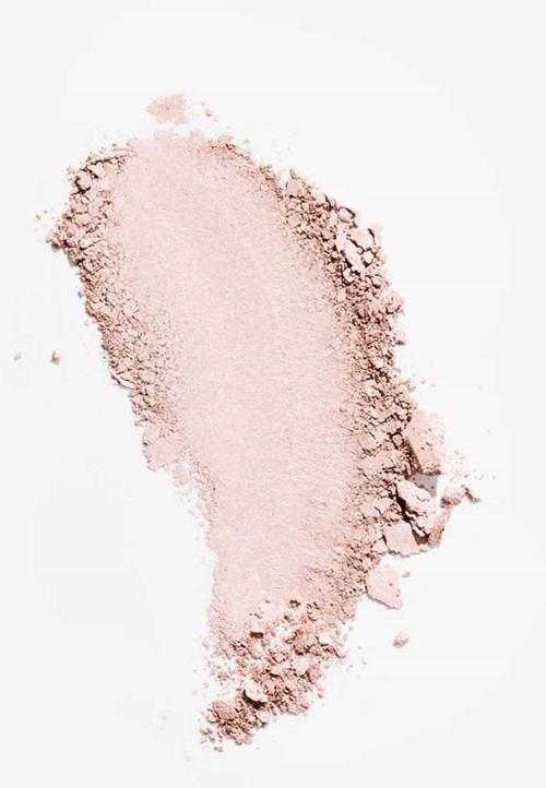 A light pink powder scattered on a white background, with a concentrated area and some loose particles around.