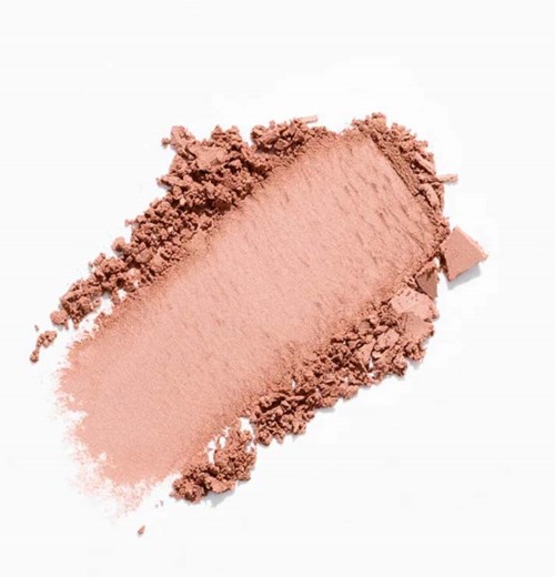 A pink powder spread on a white background, with some parts more crushed than others.