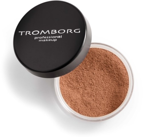 A round container of brown powder labeled Tromborg professional makeup, with a black lid.