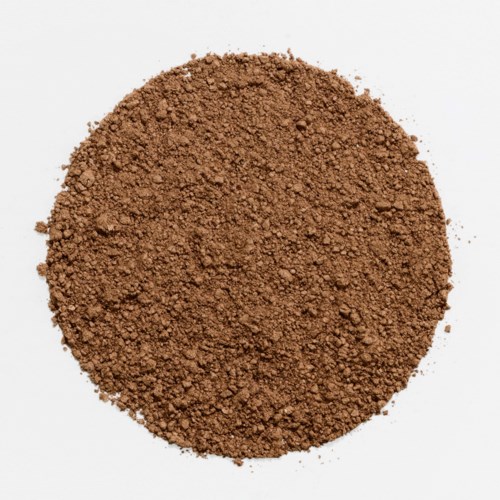 A round pile of ground brown powder on a white background.