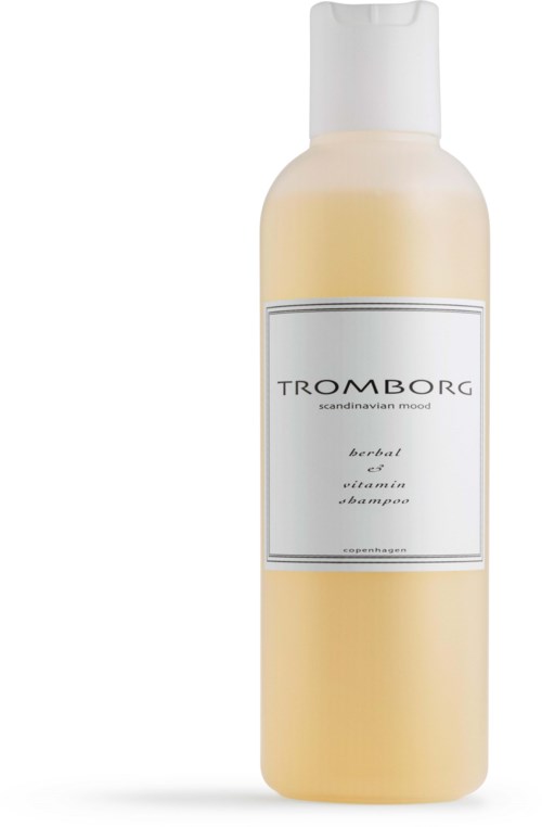 En vit flaska med fliplock, märkt 'Trombrog', verkar vara ett ört- och vitamin-shampo.