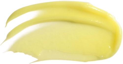 A yellow cream is spread on a white background, with three brush strokes visible.