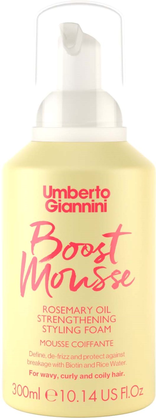 A yellow bottle with a white pump, labeled 'Umberto Giannini Boost Mousse' in pink and red text for curly hair.