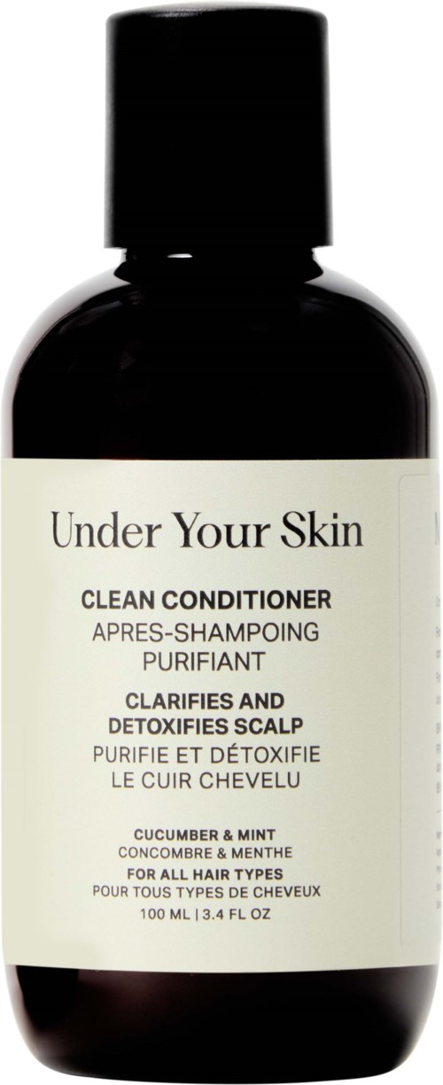 Een zwarte fles met 'Under Your Skin' label, bevat shampoo met komkommer, munt en menthol voor de hoofdhuid.