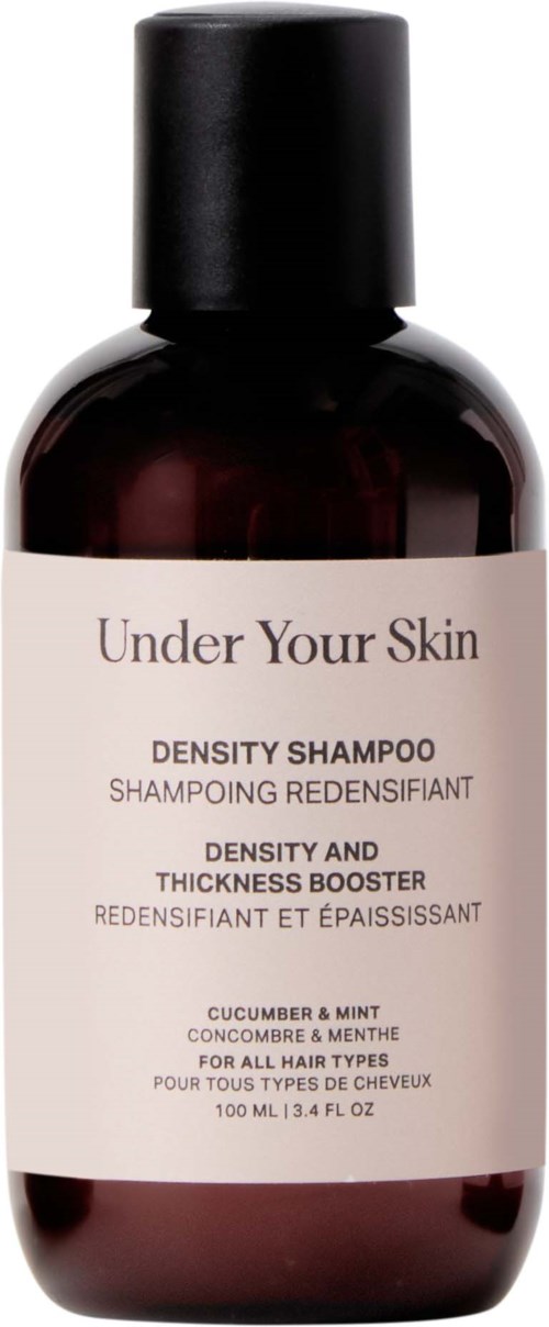 Een donkerkleurige fles Under Your Skin Density Shampoo met een lichte label en zwarte dop.