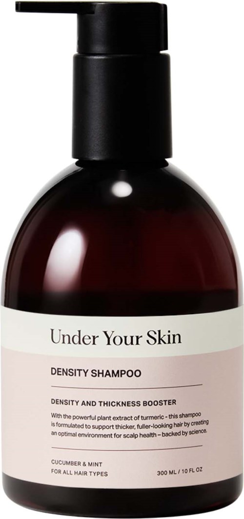 Een donkerbruine shampoo fles met een zwart pompje, gelabeld "Under Your Skin" en "Density Shampoo" voor haarverzorging.