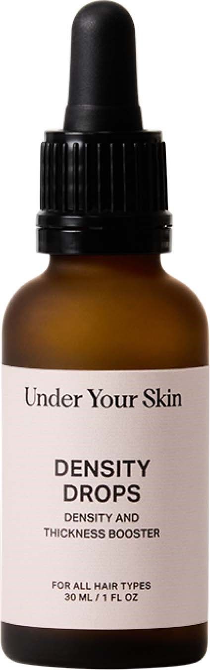 Een klein bruin flesje met een zwarte druppelcap, met label 'Under Your Skin Density Drops', voor haarverzorging.