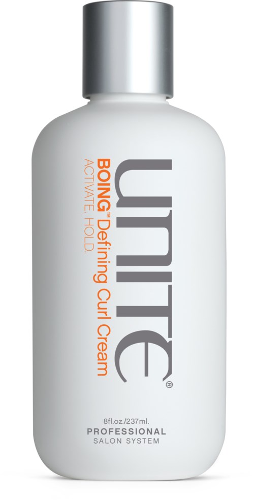A white bottle with a silver cap that says "UNITE" and mentions strong hold curling cream.