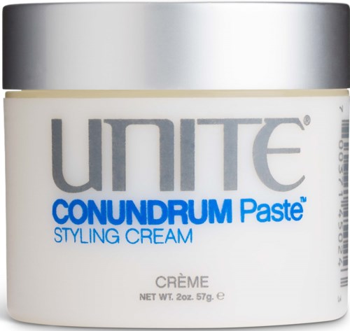 A white jar labeled 'UNITE CONNDRUM Paste Styling Cream' with a silver lid.