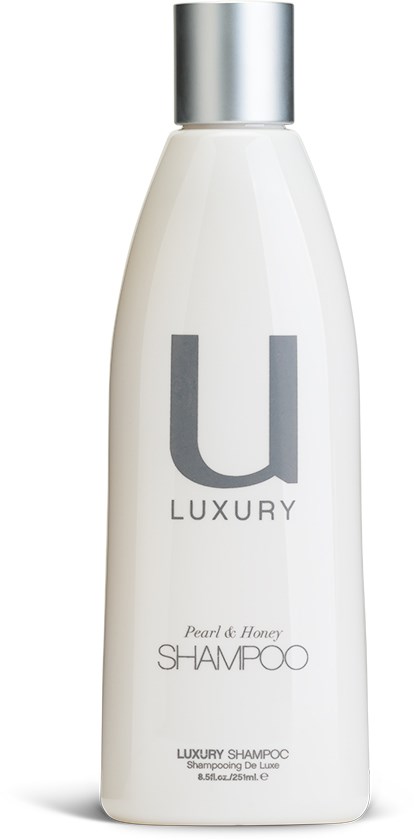 Eine weiße Shampoo-Flasche mit silberner Kappe, beschriftet mit 'U LUXURY' und 'Pearl of Honey.'