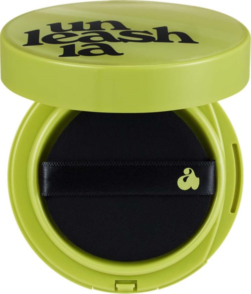 A round, green container with cleanser, a black sponge inside, and the words "fun less lash" on the lid.