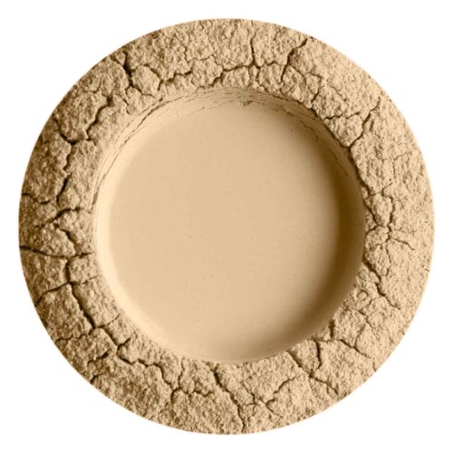 Ein runder, beige, rissiger Stein- oder Tonring mit einem Hohlraum in der Mitte, ähnlich einem Donut.