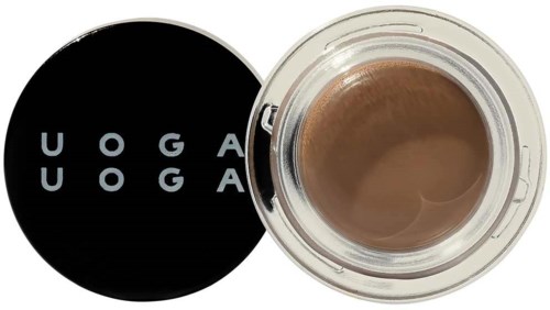 Cremebehälter mit schwarzem Deckel, der den Markennamen 'UOGA UOGA' zeigt.