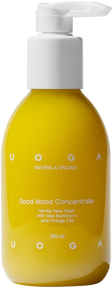 Gelbe Flasche mit weißem Pump, bezeichnet als 'Good Mood Concentrate' für Hautpflege mit Orange und Samenextrakt.