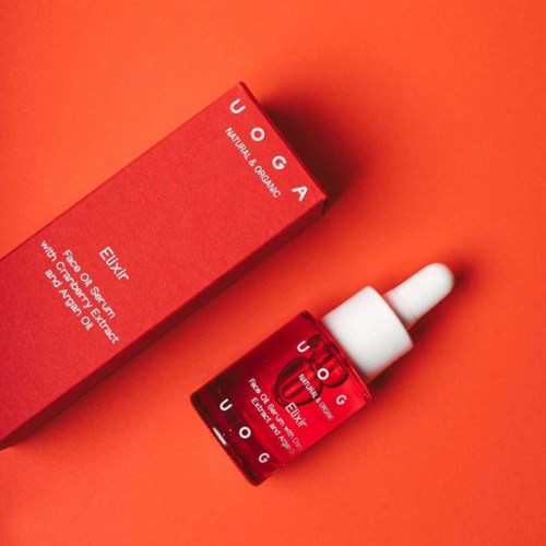 A red box and a small bottle with a dropper, labeled for skin care with natural ingredients.