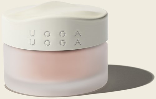Ein Behälter mit weißem Deckel, rosa Körper und erhabene Buchstaben, die 'UOGA' buchstabieren.
