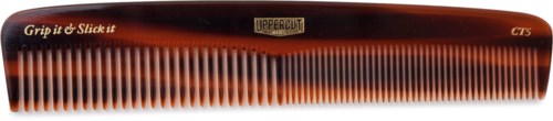 A grooming comb labeled 'UPPABRUSH' with orange and black colors and the words 'Grip it & Slick it' on it.