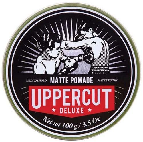 A circular logo with two men boxing, text about hair pomade, and a red banner saying 'UPPERCUT DELUXE.'