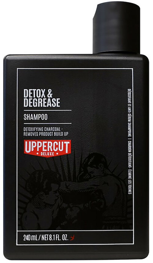 Black bottle of shampoo labeled for detoxifying charcoal, removing product build-up, by Uppercut Deluxe.