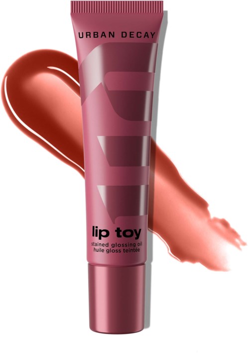 Urban Decay läppglansrör med rosa lock, med ett lip gloss-svall i rosa bakom.