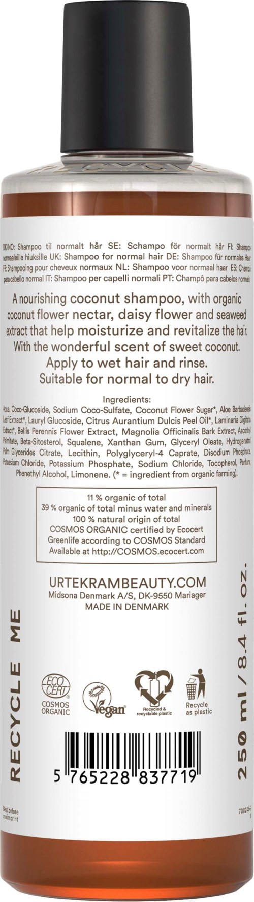 Eine braune und klare Shampoo-Flasche mit schwarzem Deckel, viel Text und Symbolen auf der Etikette.
