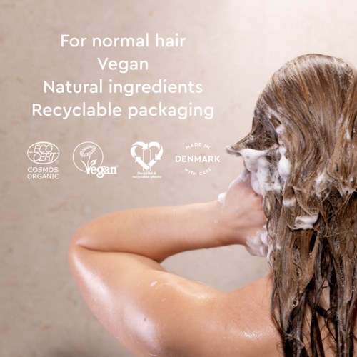 A person with long, wet hair washing their head, with text about vegan and natural hair products.