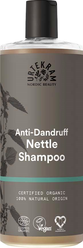 Een grijze fles nettel shampoo met zwarte dop, labelt als anti-roos, biologisch, veganistisch en natuurlijk.