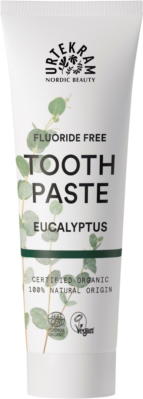 A white tube of fluoride-free eucalyptus toothpaste with green leaf designs and certification icons.