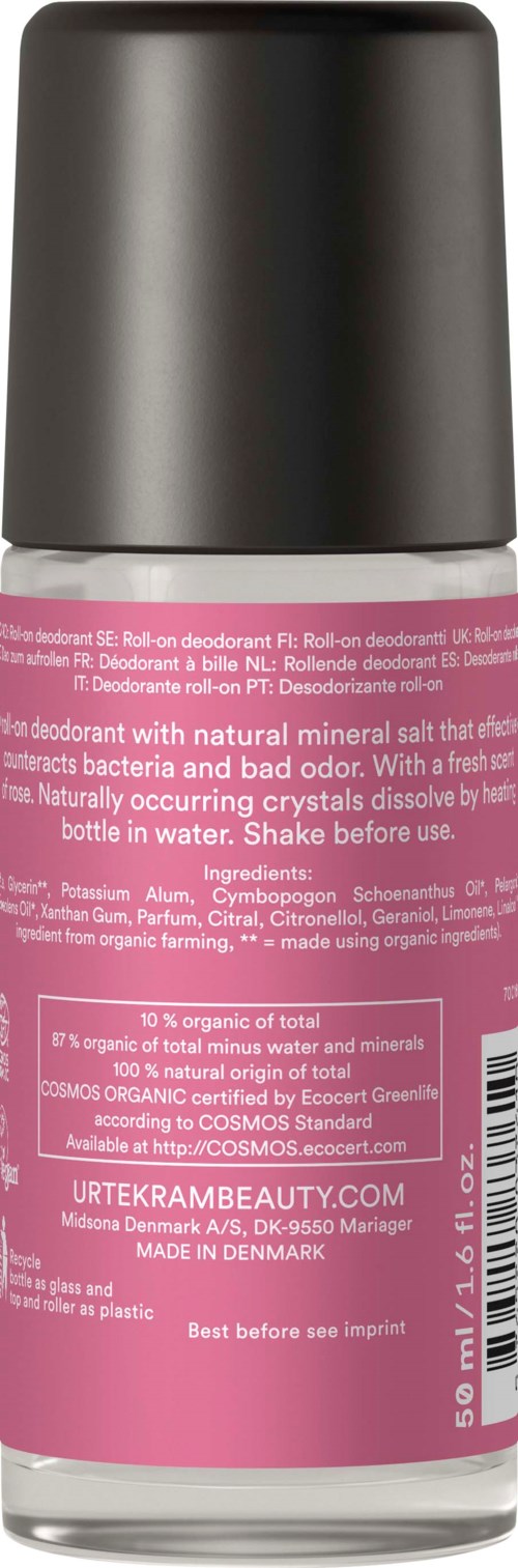 Een roze en zilveren cilindervormige deodorantspray met tekst over ingrediënten en gebruiksaanwijzingen.