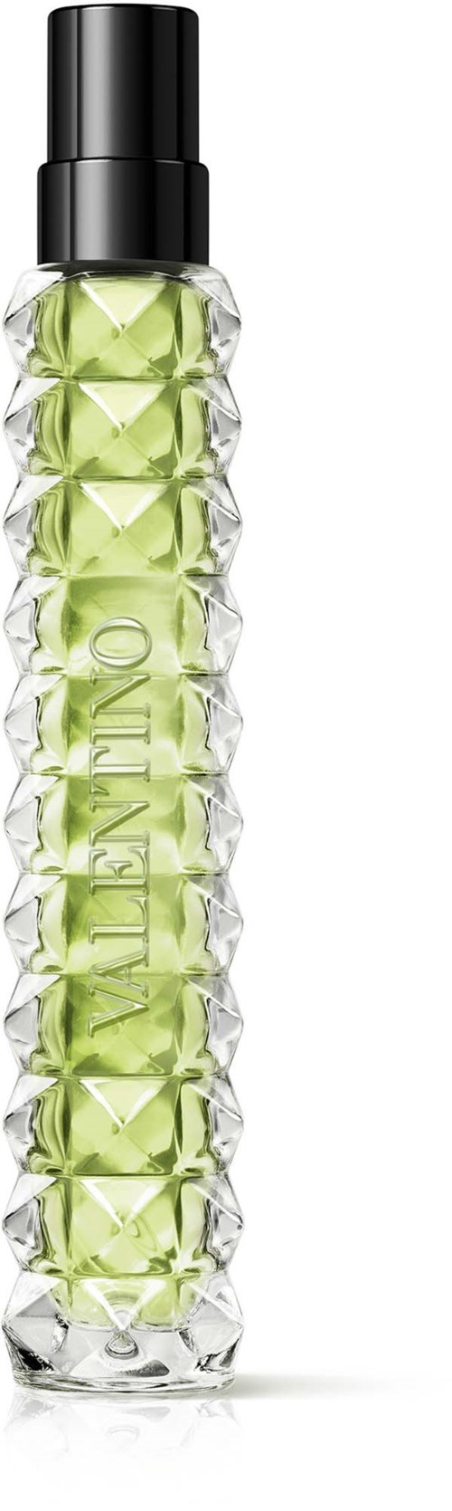 Eine kristallförmige Parfümflasche mit schwarzem Deckel und grüner Flüssigkeit.