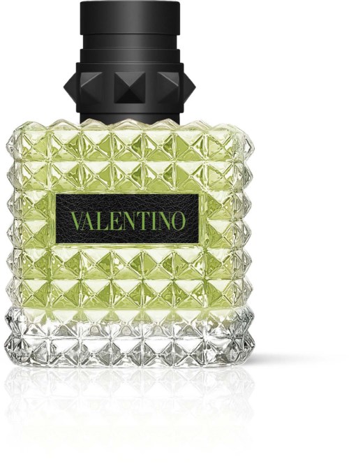 A perfume bottle with a textured design, black cap, and a black label with green text saying "VALENTINO."