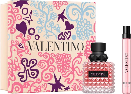 Ein Valentinstag-Geschenkset mit einer Schachtel, Parfümflasche und rosa Spray.