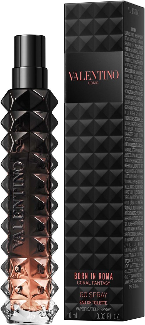 Ein Parfühflasche mit diamantartigem Muster in Schwarz und Kupferfarben, zusammen mit schwarzer Verpackung mit roter und weißer Schrift.