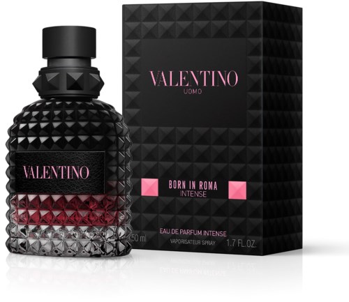 A black perfume bottle with a diamond pattern and pink label, next to a black box with similar pattern and pink accents.