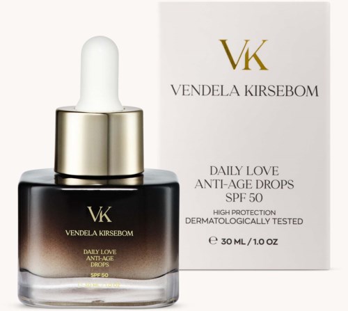 A black and gold bottle with a dropper, and a white box with gold and black text for skincare product.
