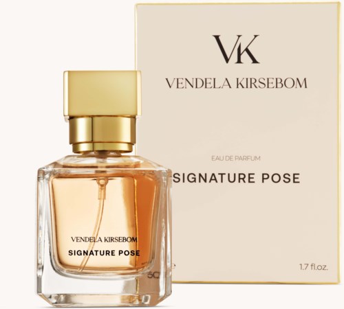 A perfume bottle with a gold cap and beige liquid, placed next to a matching white box with text.
