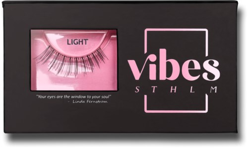 A black box with pink accents, holding false eyelashes and the words 'Light' and 'Vibes' on it.