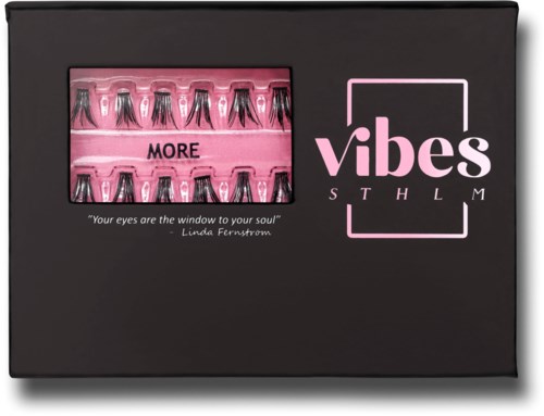 Black box with a pink window showing small vials, and the words "vibes STHLM" in pink on the front.