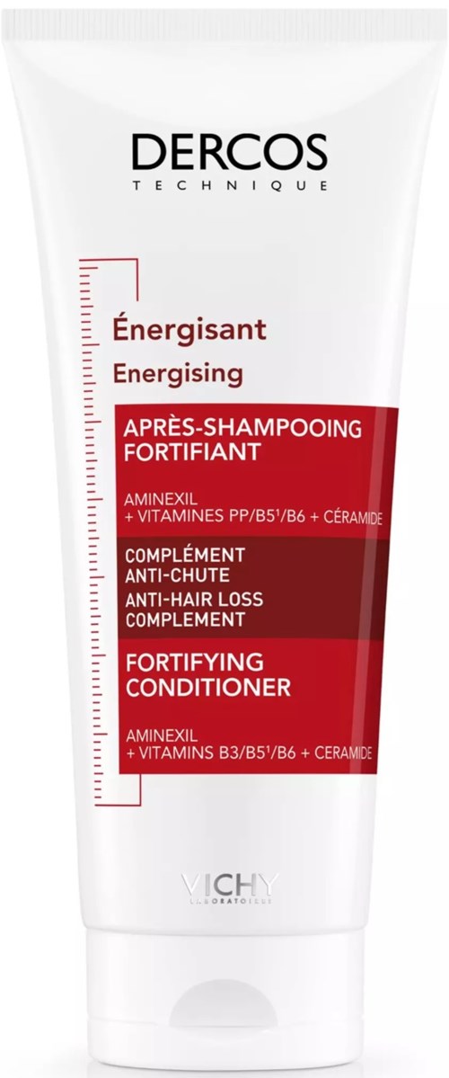 Es ist eine Tube DERCOS Shampoo mit roten und weißen Aufklebern zur Haarverstärkung und Haarausfallbekämpfung.
