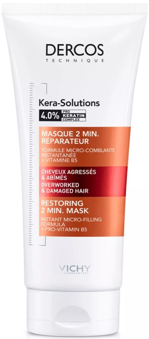 Ein weißer Tubus mit Marke Dercos, zeigt ein Etikett für eine Haarreparaturmaske mit Keratin und Vitaminen.