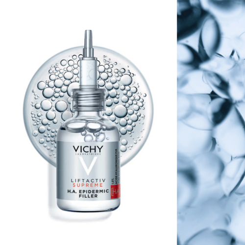 Ein Vichy Hautpflegeprodukt mit Tropfer, umgeben von Blasen, vor einem runden Hintergrund und einem strukturierten blauen Bereich.