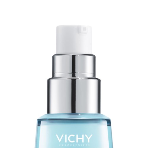 A clear bottle with white and silver cap. The bottle has blue liquid and the brand name Vichy on it.