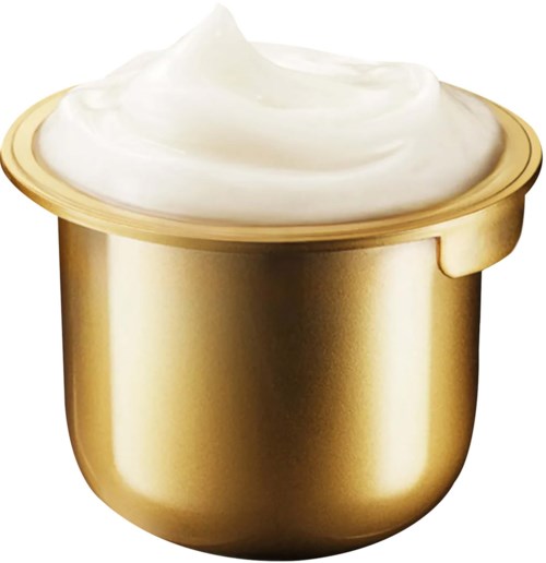 A gold container filled with white creamy skincare product.